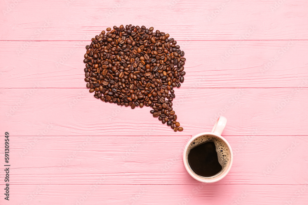 Creative composition with cup of coffee and beans on pink wooden background