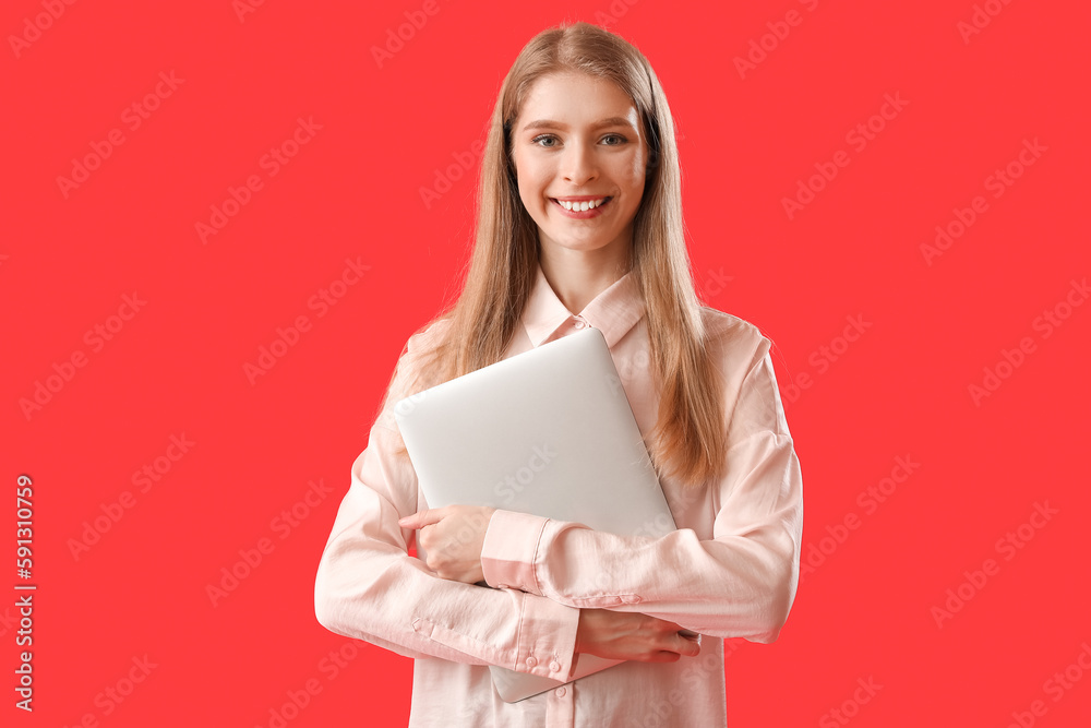 Female programmer with laptop on red background