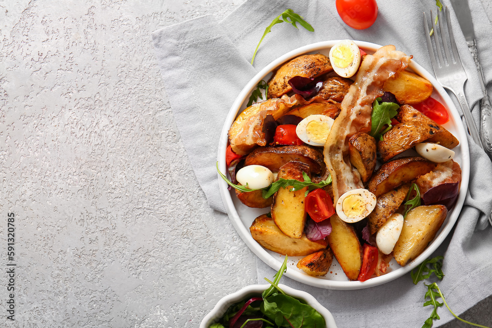 Plate of tasty potato salad with eggs, tomatoes and bacon on light background, top view