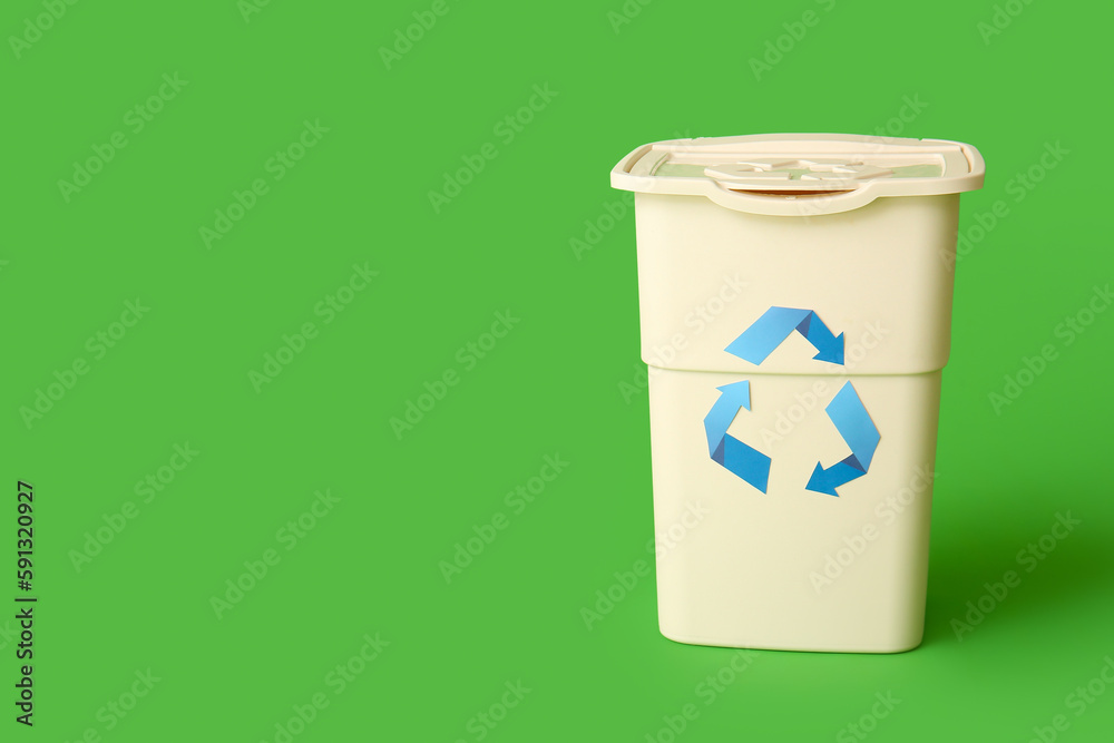 Container for garbage on green background. Recycling concept