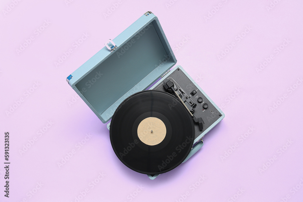 Record player with vinyl disk on lilac background