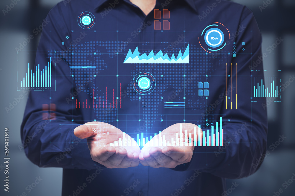 Close up of businessman hands holding glowing digital business interface with charts on blurry offic