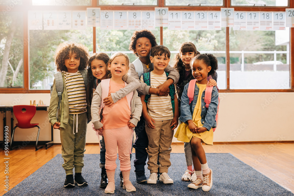 Group of elementary school students standing together in a classroom