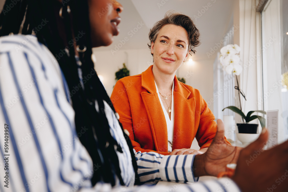 Two business women discussing business in a coffee shop