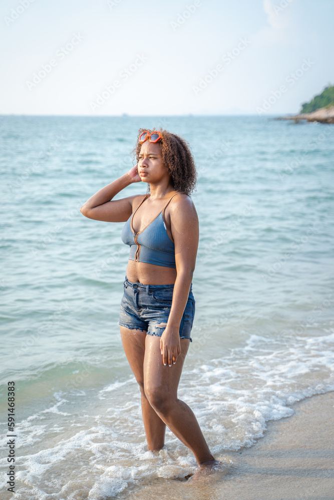 Portrait of black beautiful teenage girl having fun on sea beach,Summer vacation,Sunny hot summer da