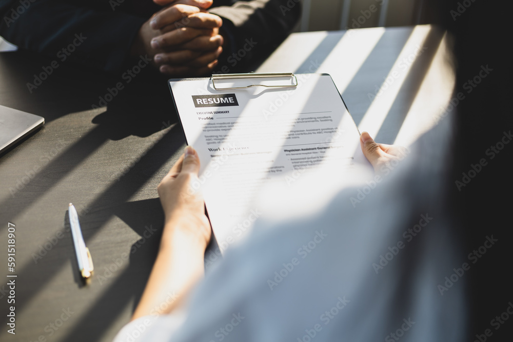 Employer in suit reading resume of job interview candidate profile collection. Woman explaining her 