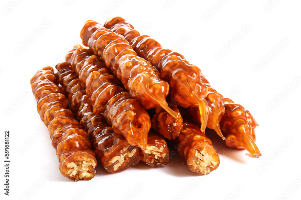 Pile of tasty churchkhela on white background