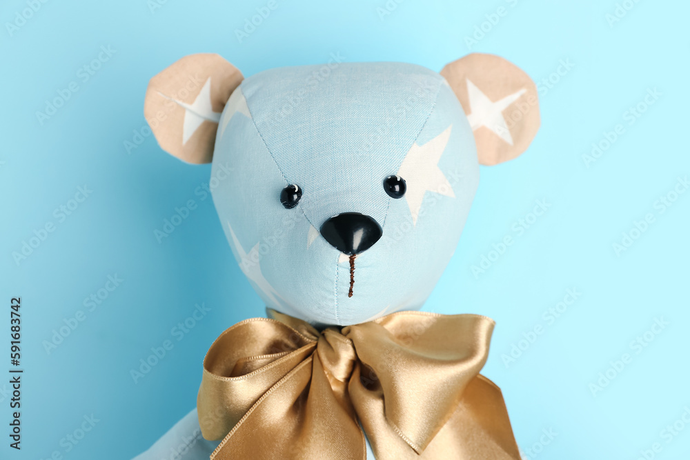 Toy bear on blue background, closeup