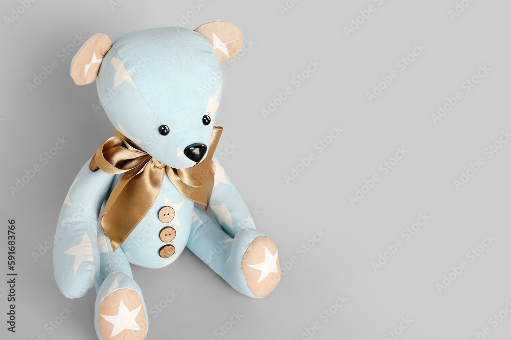 Toy bear on grey background