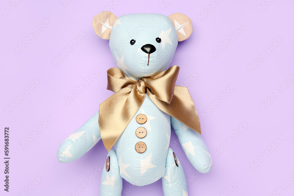 Toy bear on lilac background