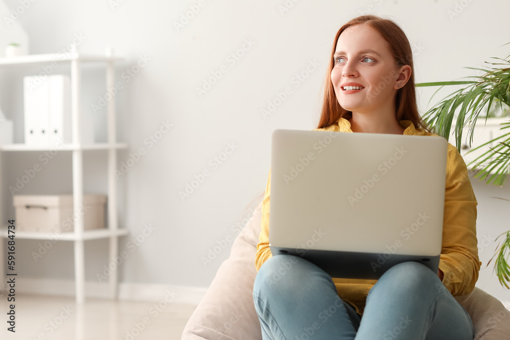 Female programmer working with laptop in office