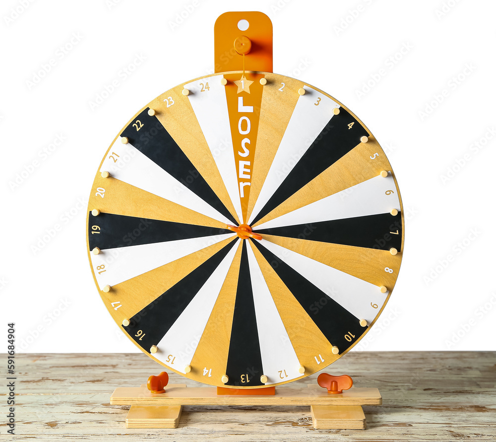 Spinning wheel with word LOSER on table against white background