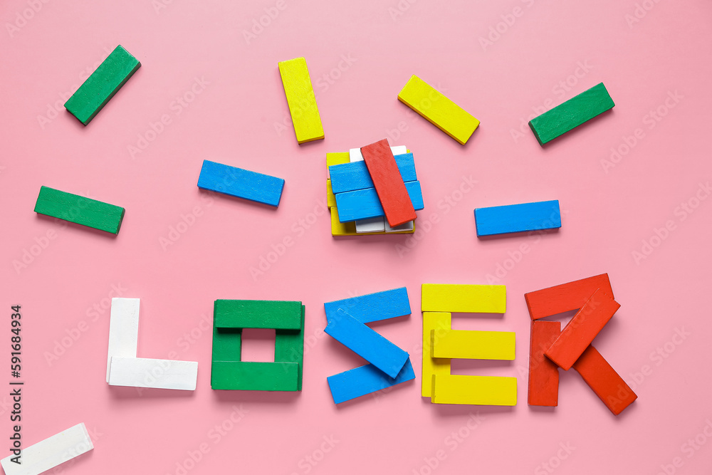 Word LOOSER made of colorful blocks on pink background