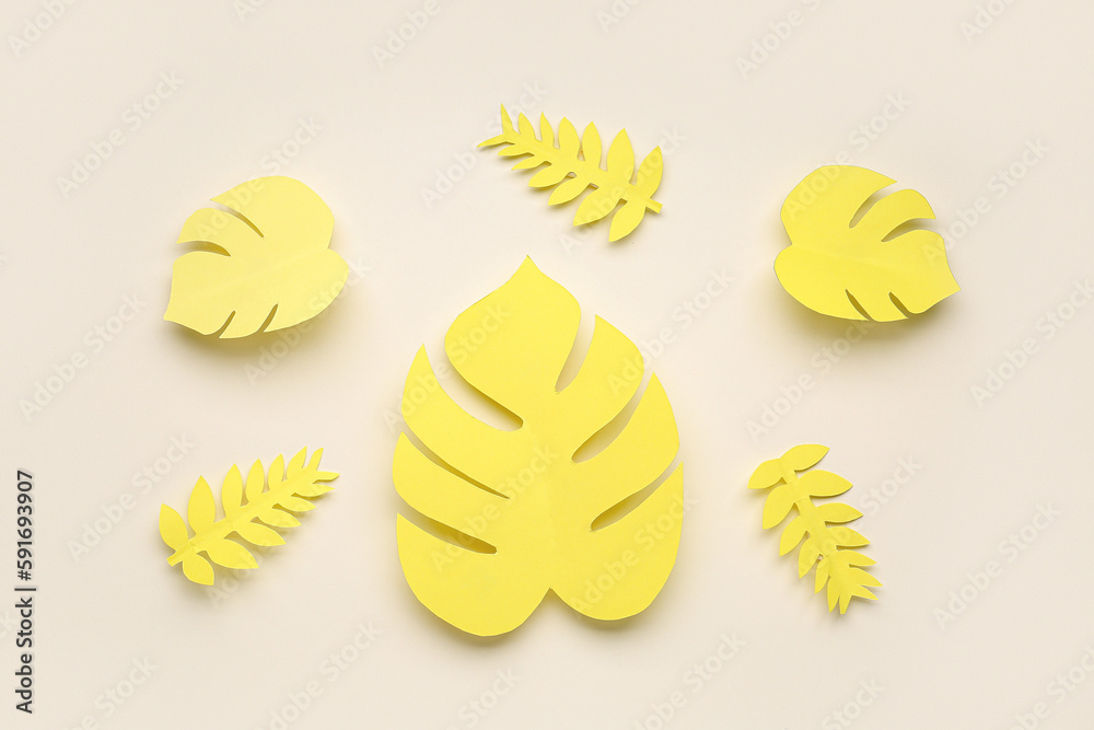 Paper tropical leaves on beige background