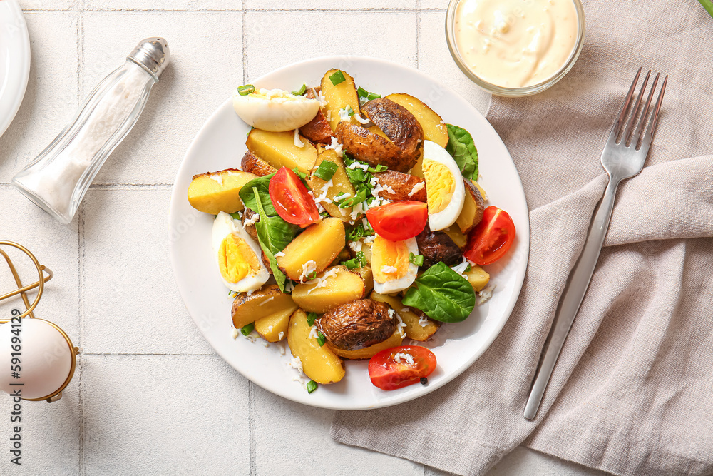 Plate of tasty potato salad with eggs and tomatoes on light background, top view