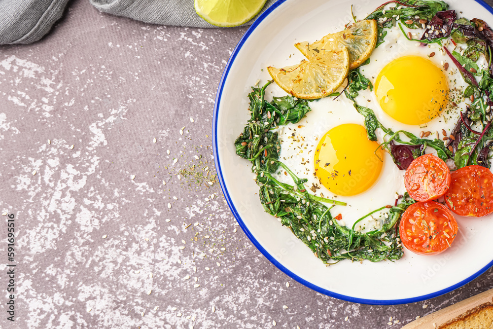 Plate with tasty fried eggs and salad on grey background