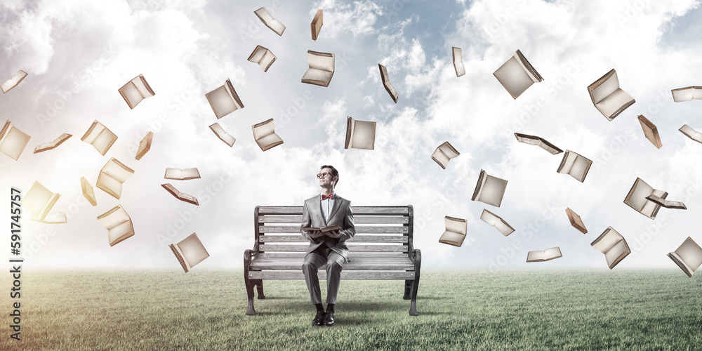 Young businessman or student studying the science and books fly around