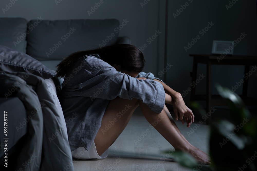 Young Asian woman in bedroom feeling sad tired and worried suffering depression in mental health