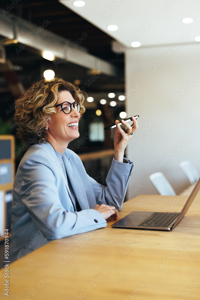 Happy business woman having a phone call conversation in an office