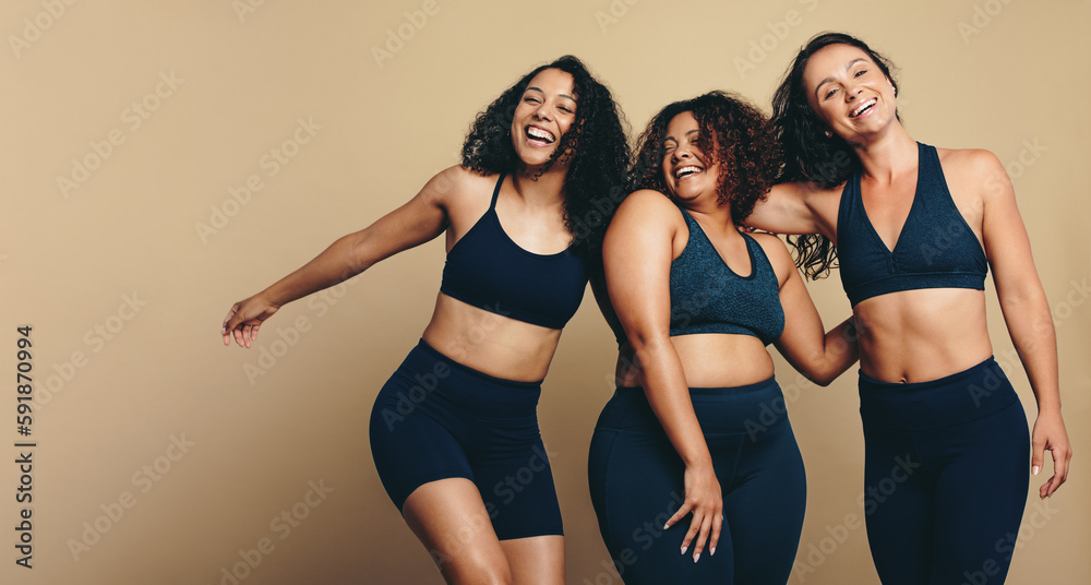 Celebrating fitness: Female friends smiling in sports clothing