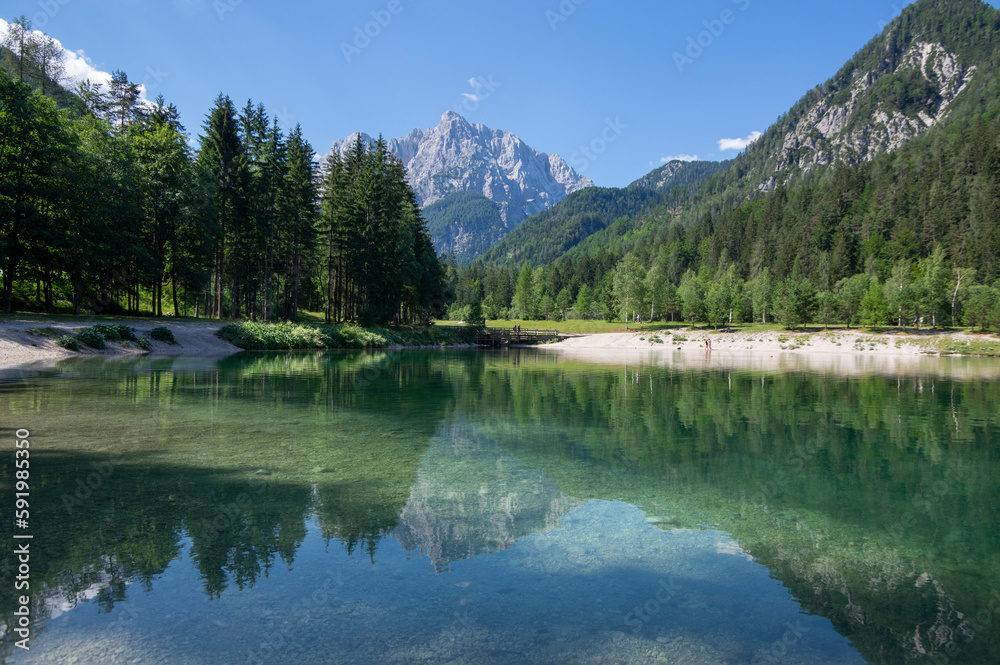 Lake called Jasna in European Slovenian Julian Alps, beautiful water surface with reflections near t