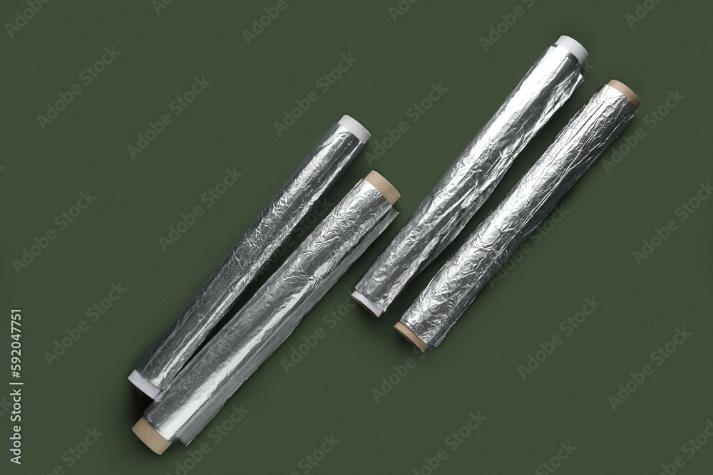 Aluminium foil rolls on green background