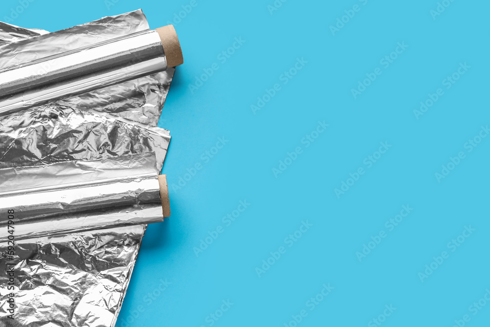 Aluminium foil rolls and sheet on color background