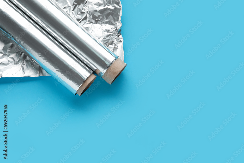 Aluminium foil rolls and sheet on color background