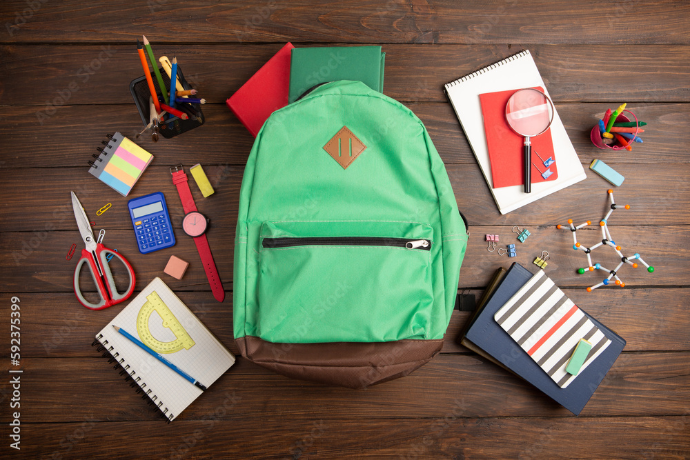 Back to school - books and school backpack on the desk in the auditorium, Education concept.