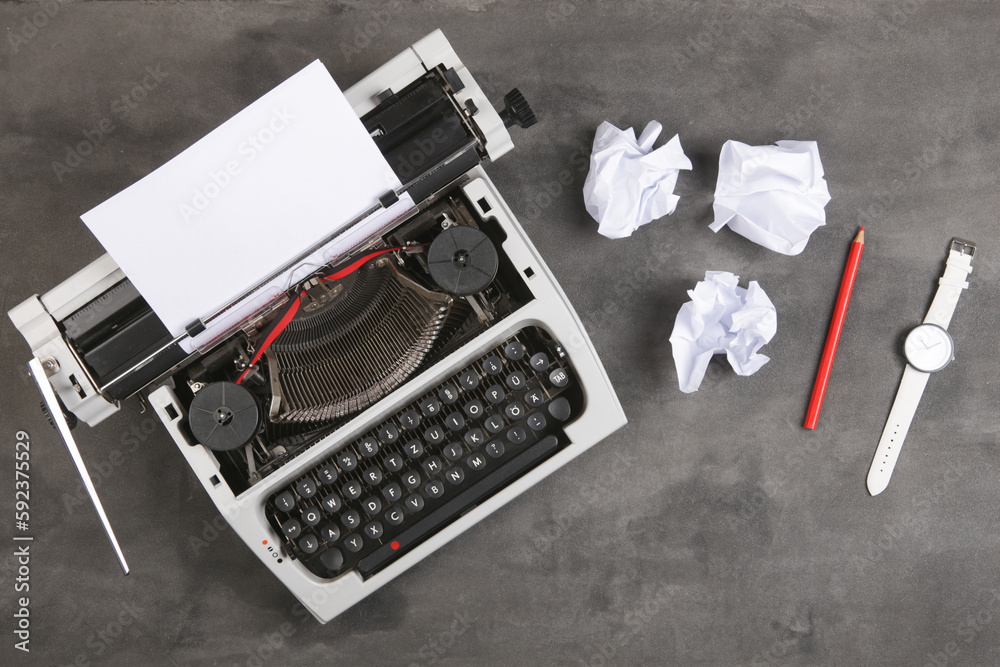 vintage typewriter on the table with blank paper on the desk - concept for writing, journalism, blog