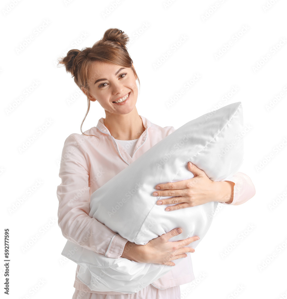 Beautiful woman in pajamas with pillow on white background