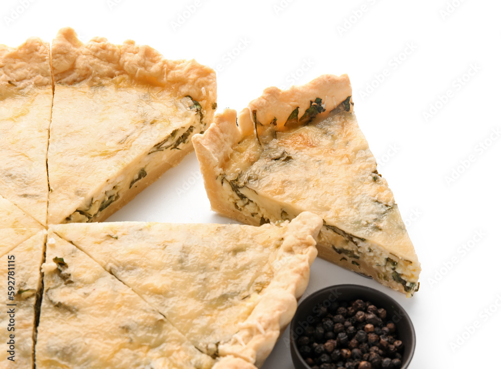 Pieces of delicious quiche and peppercorn isolated on white background