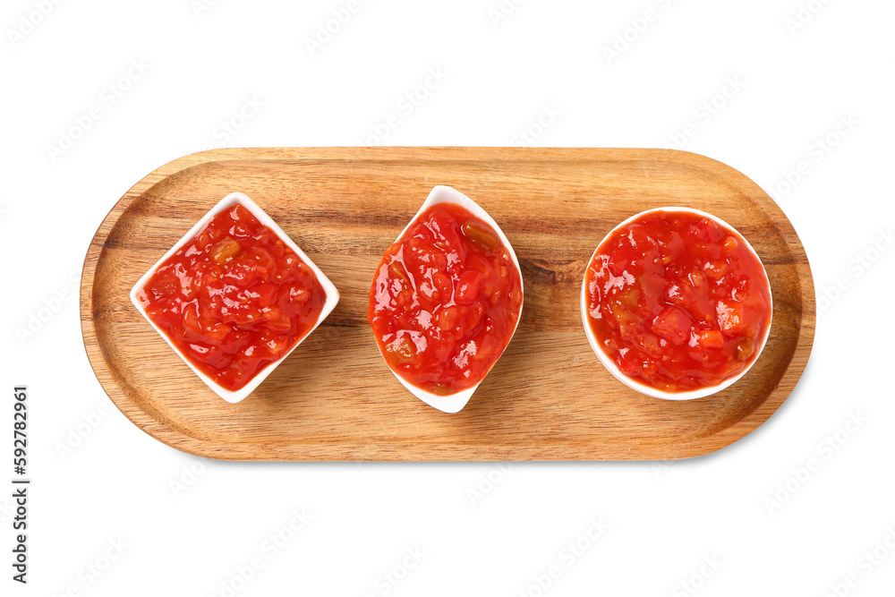 Board with different bowls of delicious salsa sauce isolated on white background