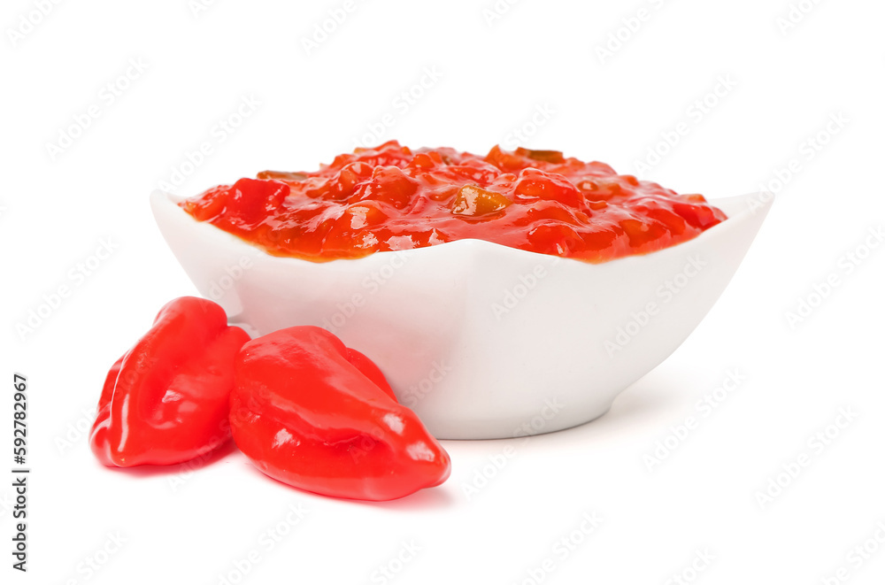 Bowl of delicious salsa sauce and peppers isolated on white background