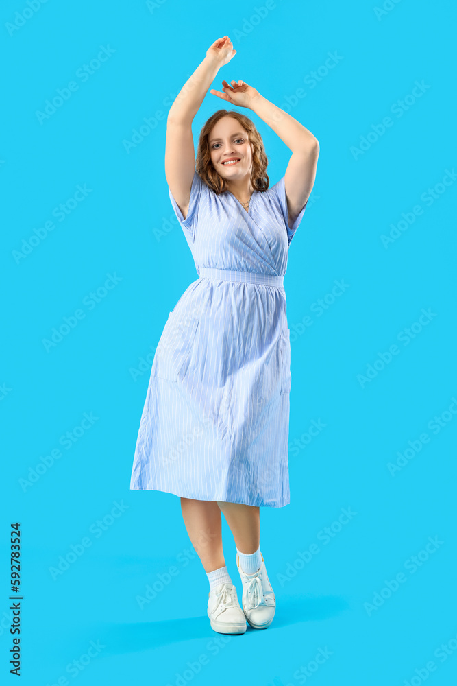 Beautiful woman with red hair on blue background