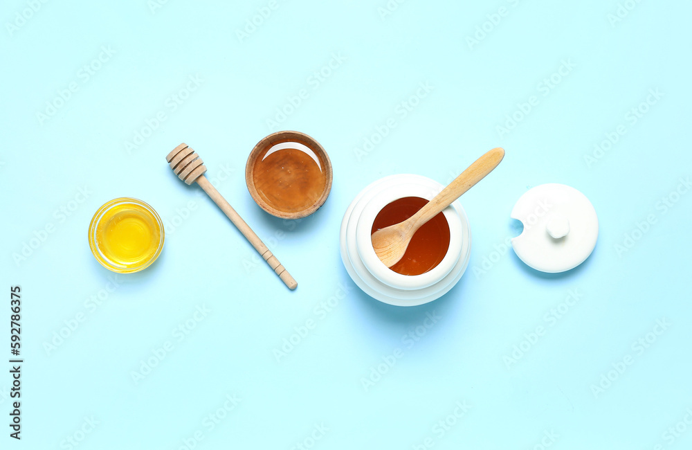 Composition with sweet honey and dipper on blue background