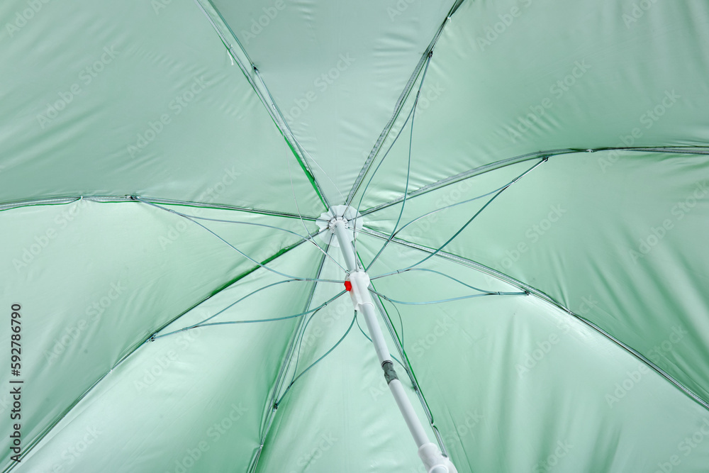 Green beach umbrella as background