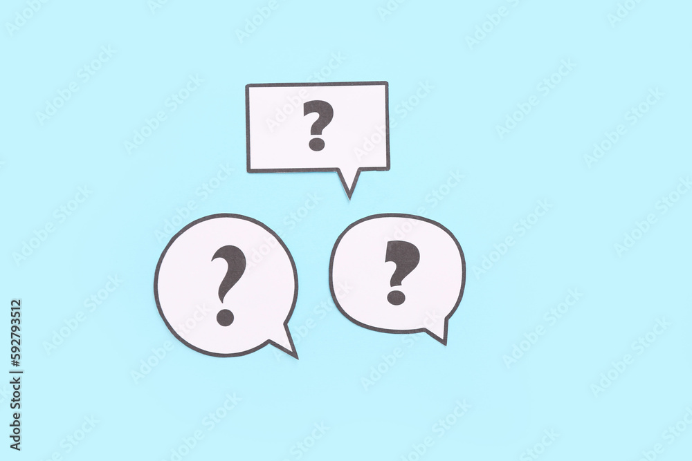 Speech bubbles with question marks on blue background