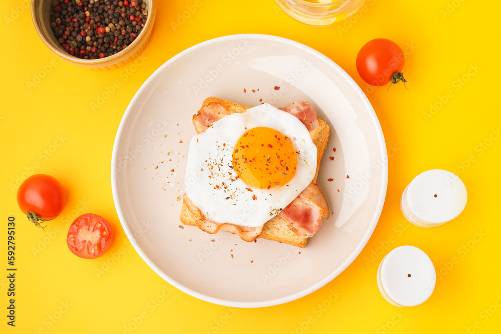 Delicious sandwich with fried egg and bacon on yellow background