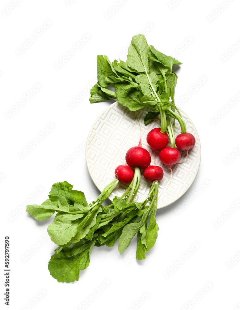 Plate of ripe radish with green leaves isolated on white background