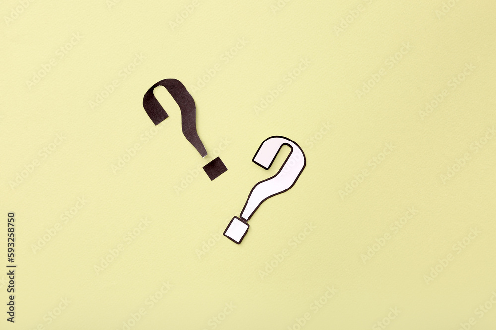 Paper question marks on yellow background