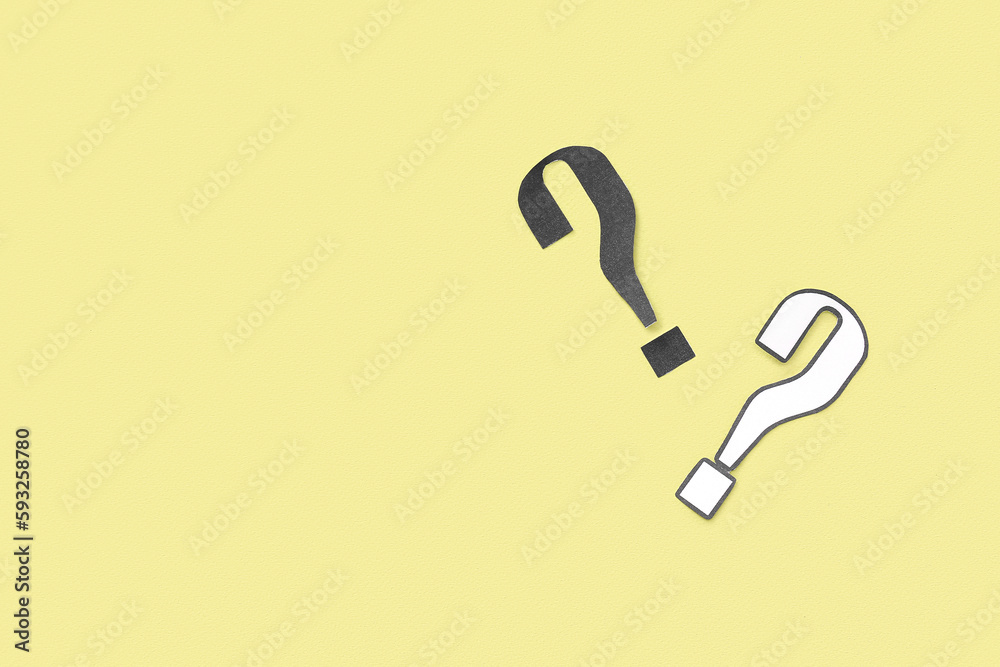 Paper question marks on yellow background