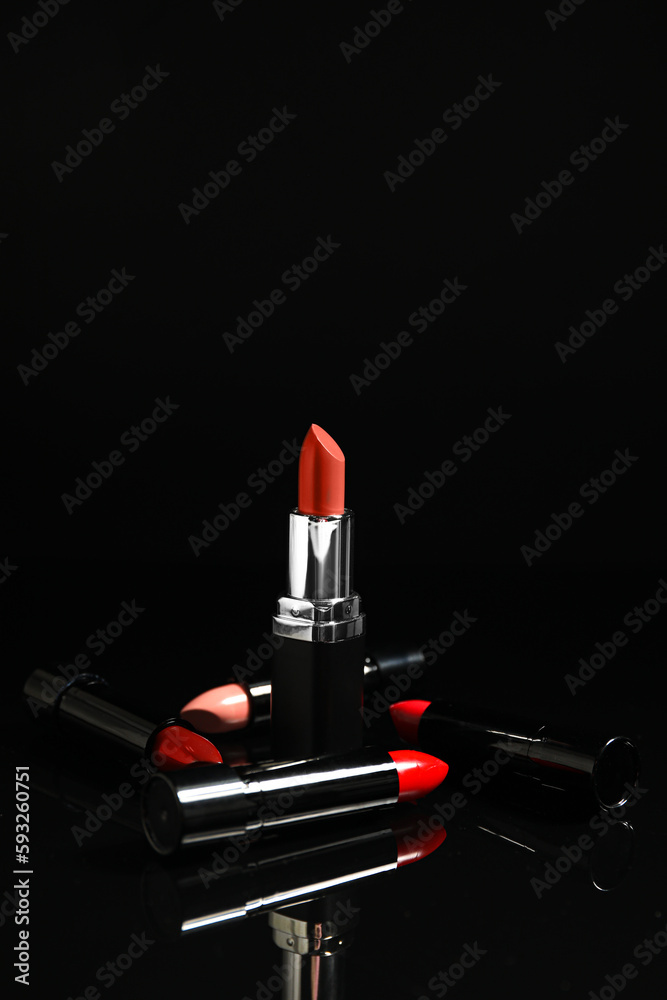 Set of beautiful lipsticks on dark background