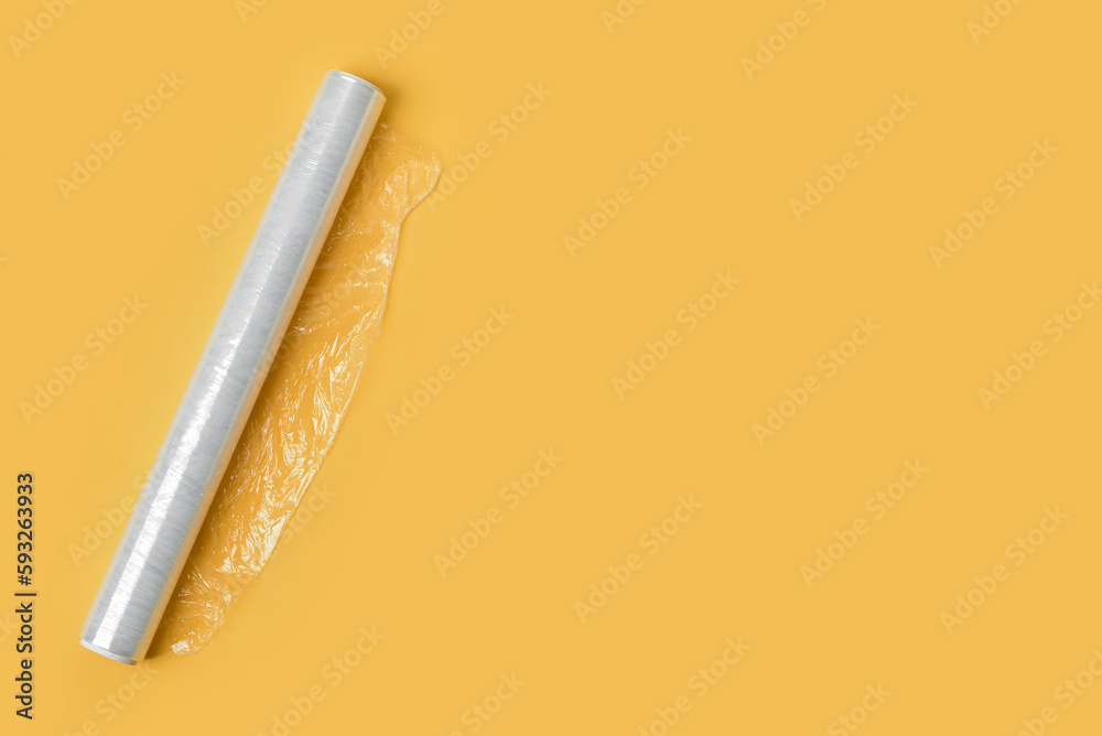 Roll of stretch wrap on yellow background