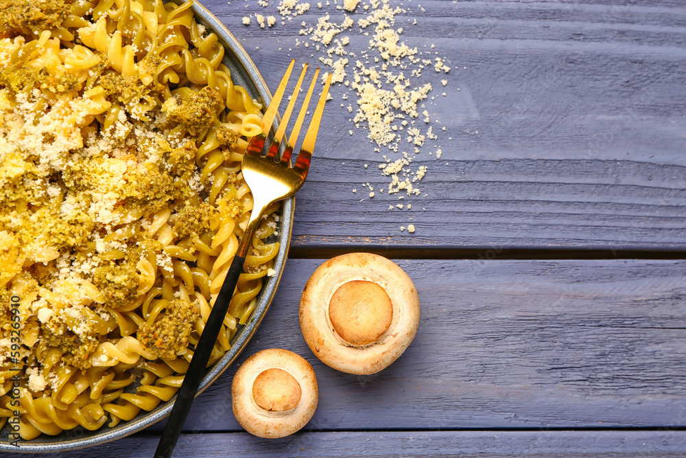 Plate of tasty Italian pasta with Parmesan cheese on wooden background, closeup