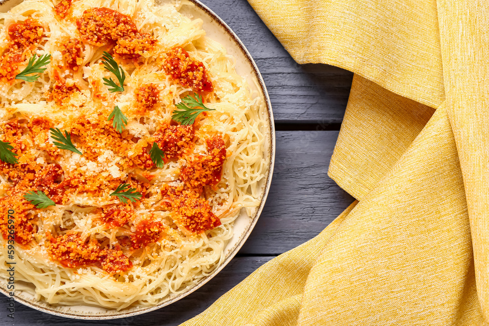 Plate of tasty Italian pasta with Parmesan cheese on table, closeup