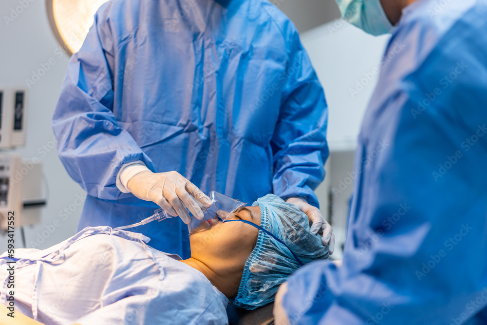 Professional doctors performing surgical operation in operating room. 