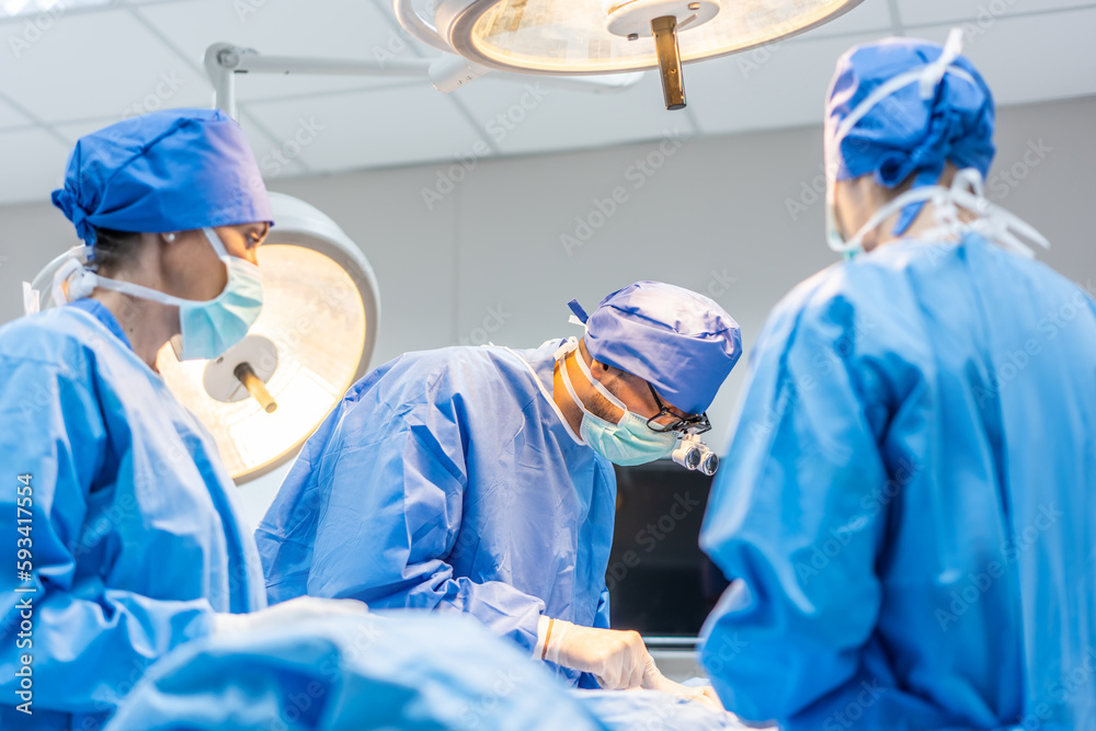 Professional doctors performing surgical operation in operating room. 