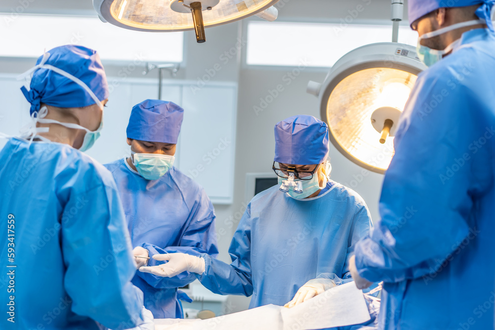 Professional doctors performing surgical operation in operating room. 