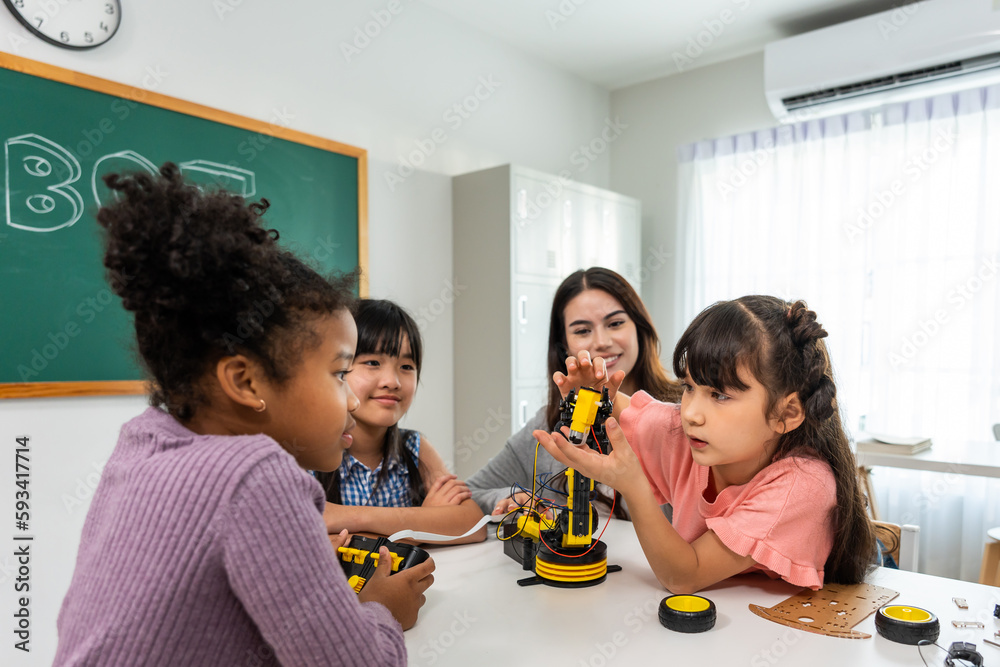 Group of student learn with teacher in classroom at elementary school.